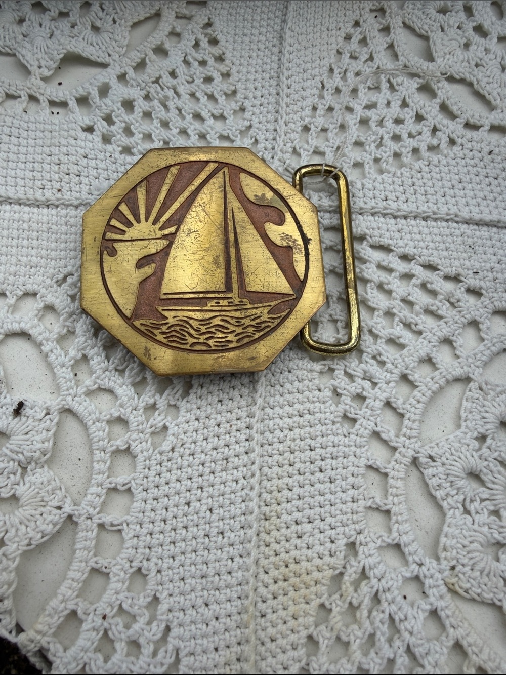 Vintage round belt buckle with sailboat